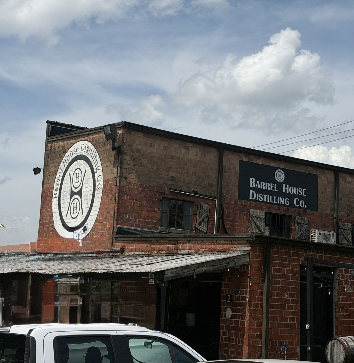 Barrel House Distilling Co. brick building with painted logo and hanging sign in Lexington