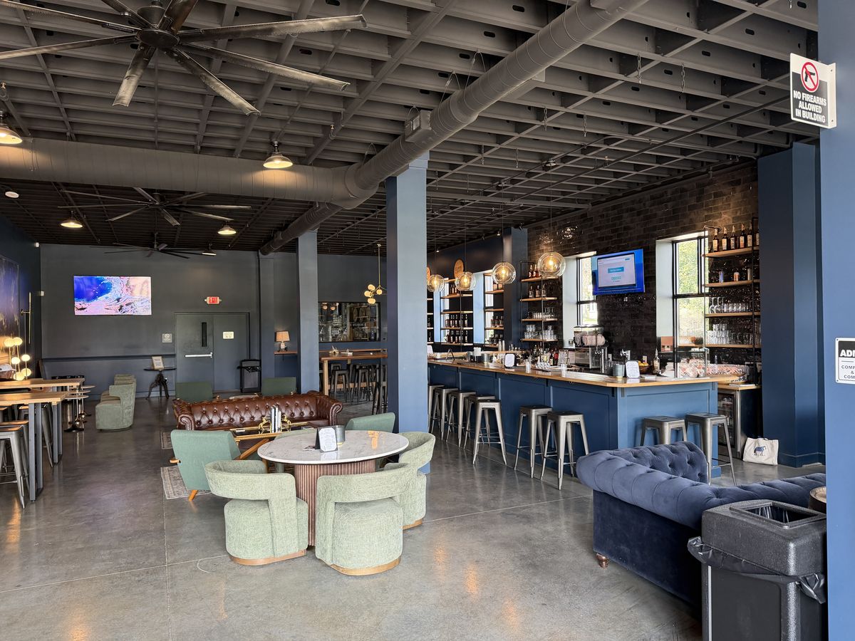 Bluegrass Distillers tasting room with leather sofas, low tables and a bar along one wall