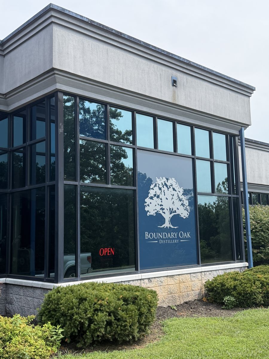 Boundary Oak Distillery exterior with the oak tree logo on the window glass