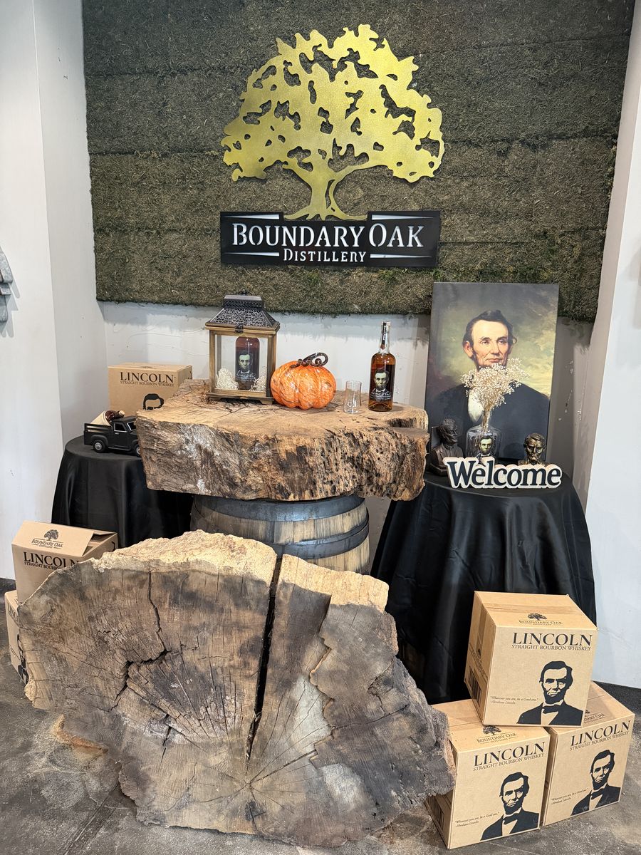 Boundary Oak Distillery sign with Lincoln branded bottle cases and a live edge wood display