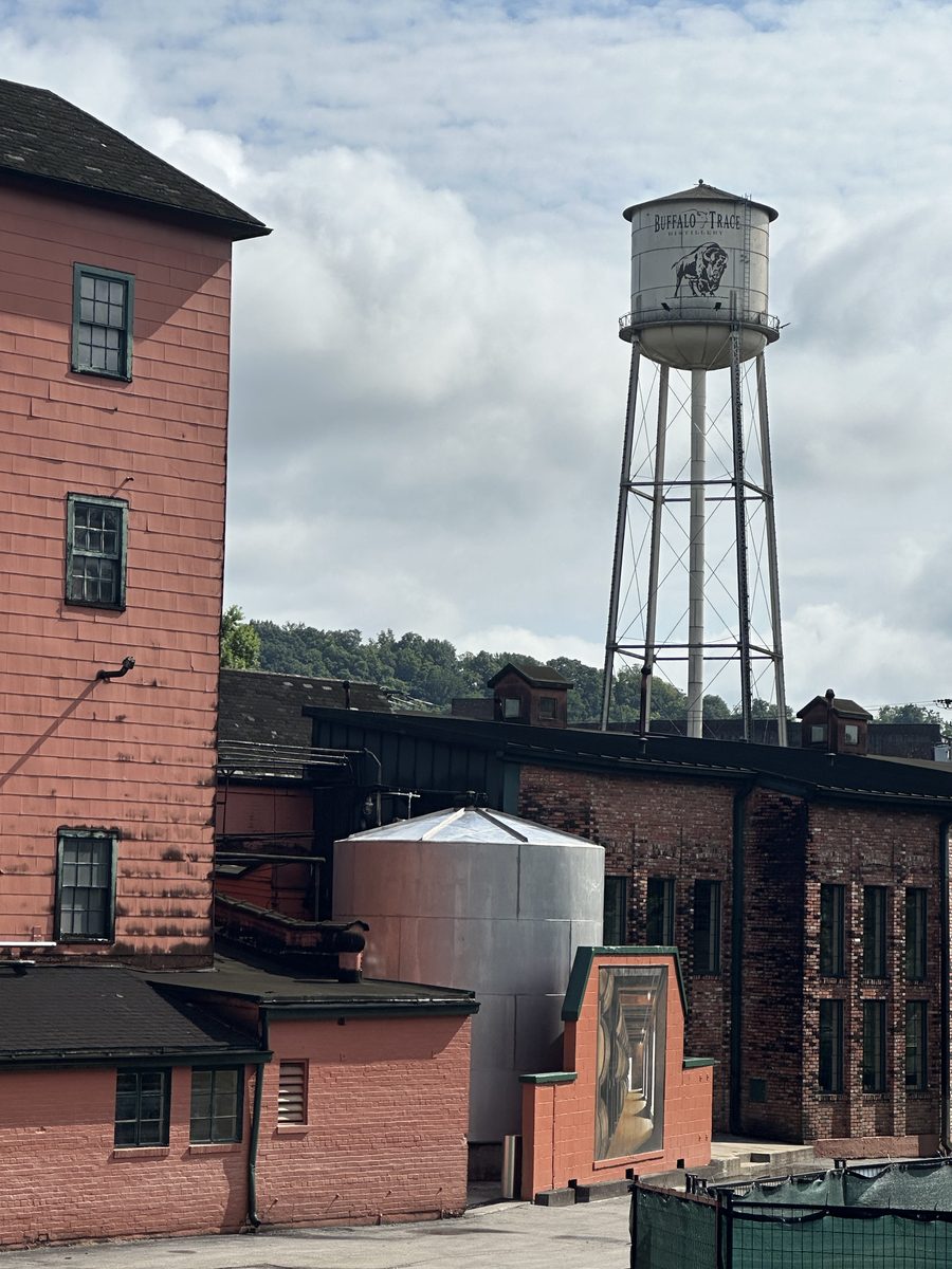 Buffalo Trace Distillery water tower with buffalo logo above historic buildings