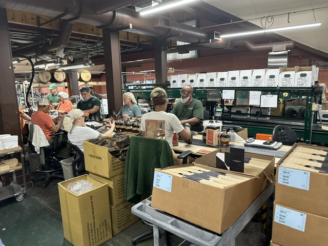 Buffalo Trace workers on the bottling line hand-labeling and packaging bottles