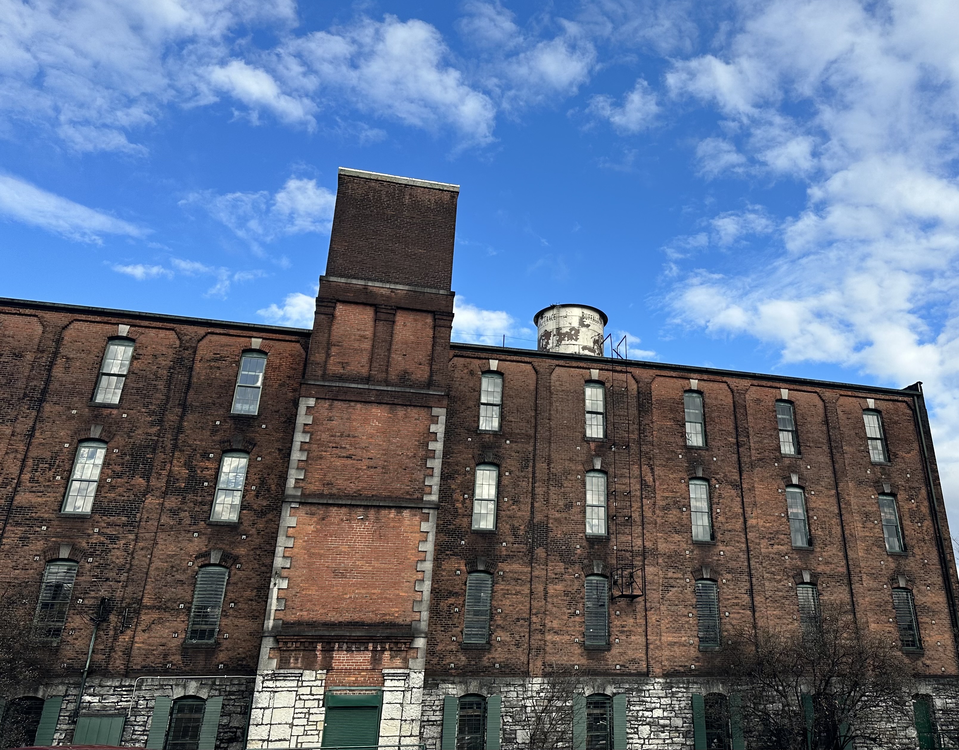 Buffalo Trace brick warehouse exterior with water tower against blue sky