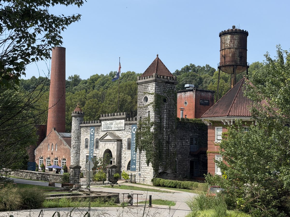 Castle and Key Distillery campus with the brick smokestack, stone castle and water tower