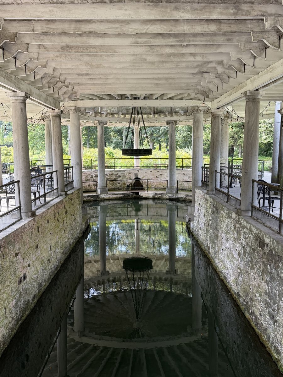 Castle and Key springhouse, a colonnade of columns around a still reflecting pool
