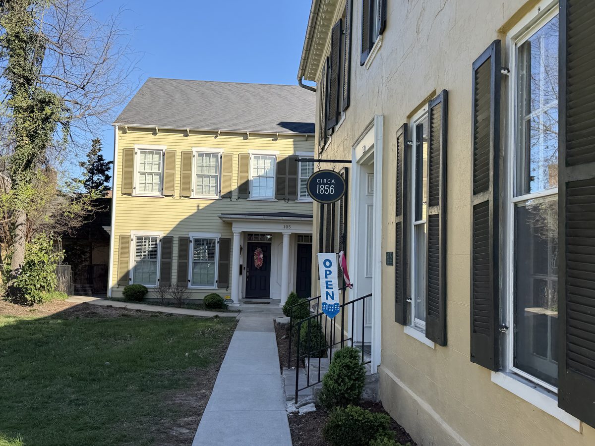 Chicken Cock Whiskey Circa 1856 yellow building exterior on Stephen Foster Ave