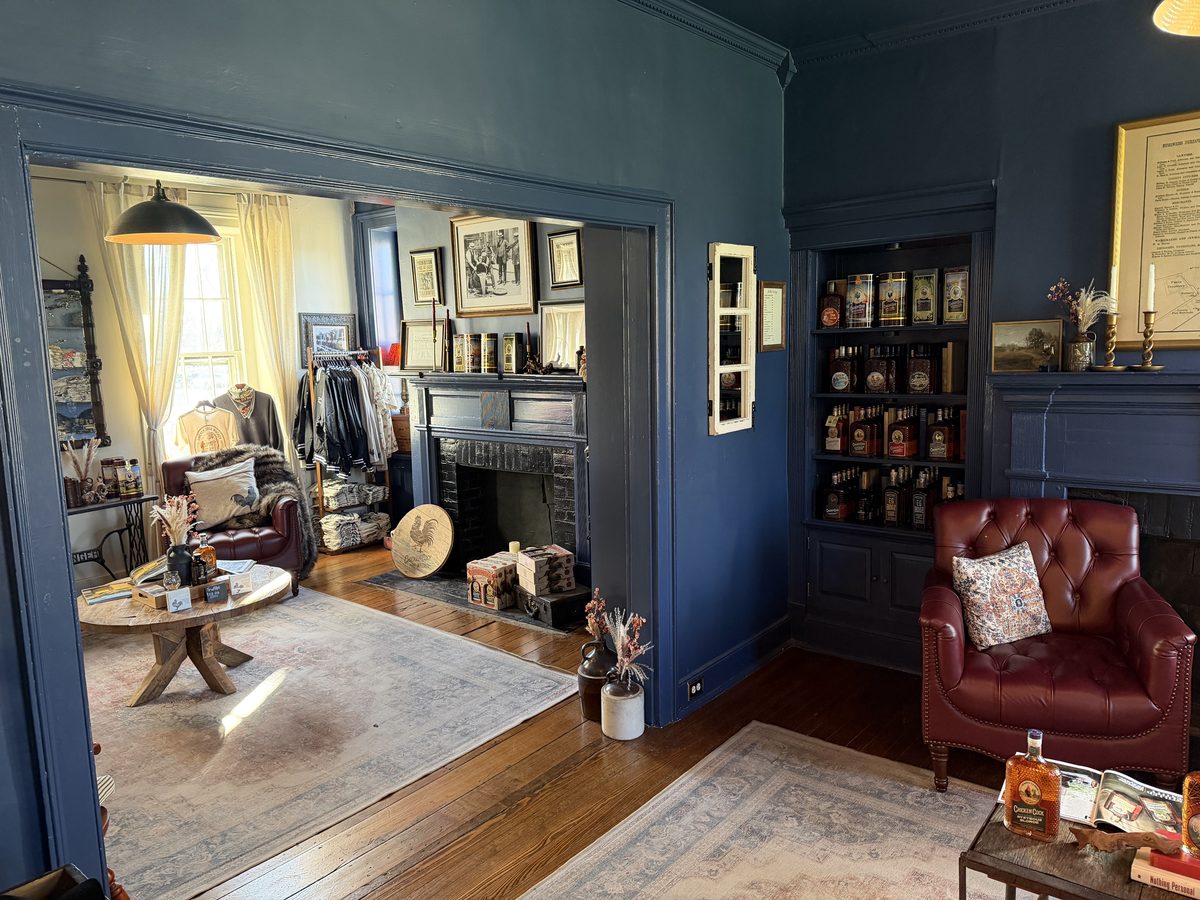 Inside Chicken Cock Circa 1856 tasting room with bottles and leather chairs