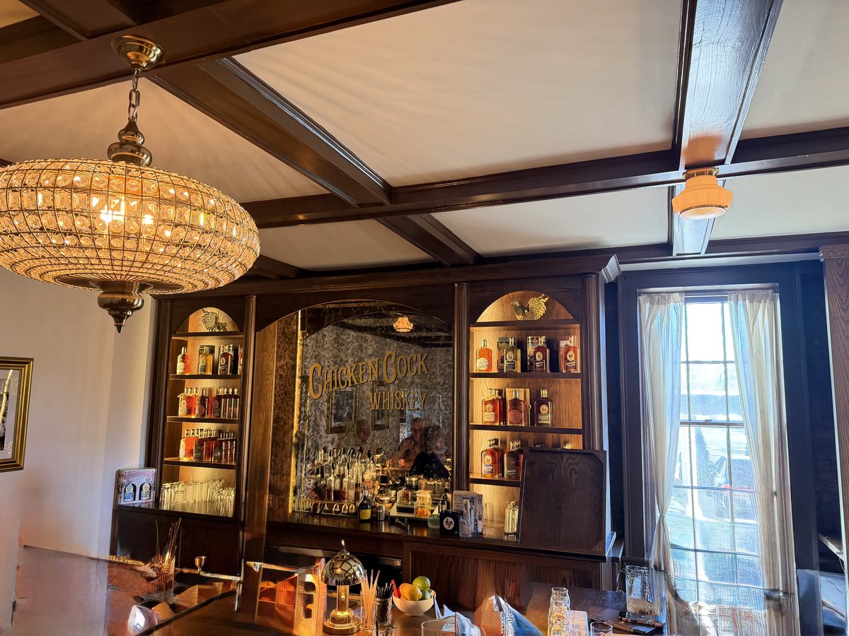 Chicken Cock Whiskey bar with chandelier and mirrored back bar