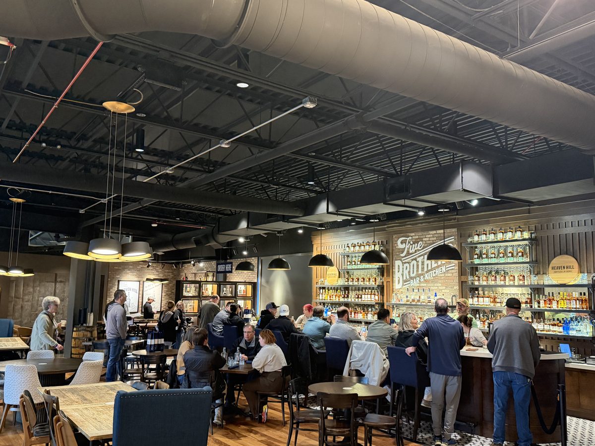 Inside Five Brothers Bar and Kitchen at Heaven Hill with guests at the bar