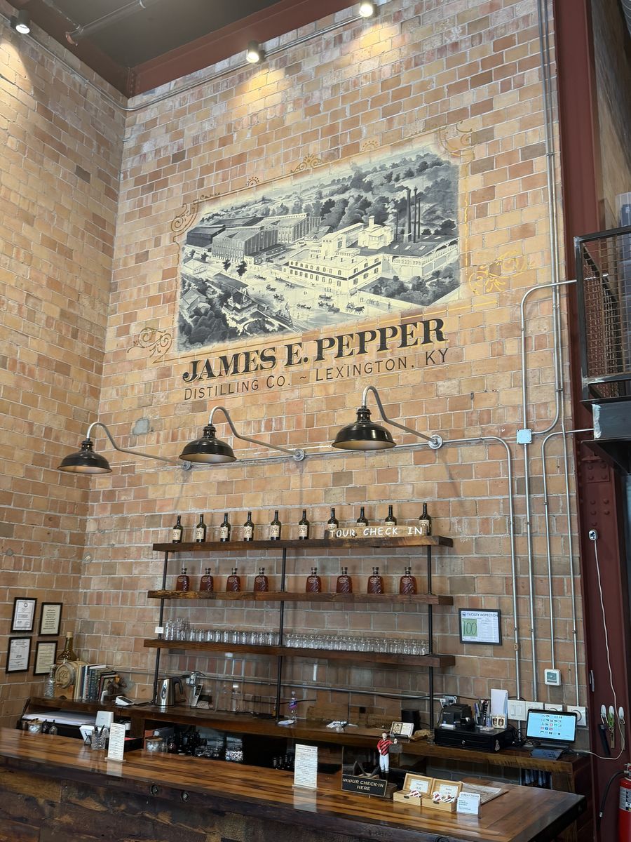 James E. Pepper tasting bar below a large historic lithograph of the original distillery