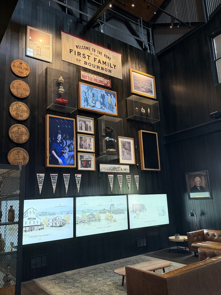 Jim Beam First Family of Bourbon wall covered in framed photographs and barrel heads