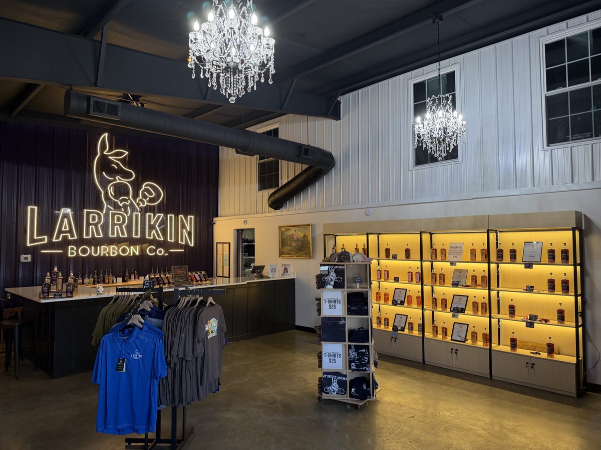 Larrikin Bourbon gift shop with lit bottle displays and merchandise