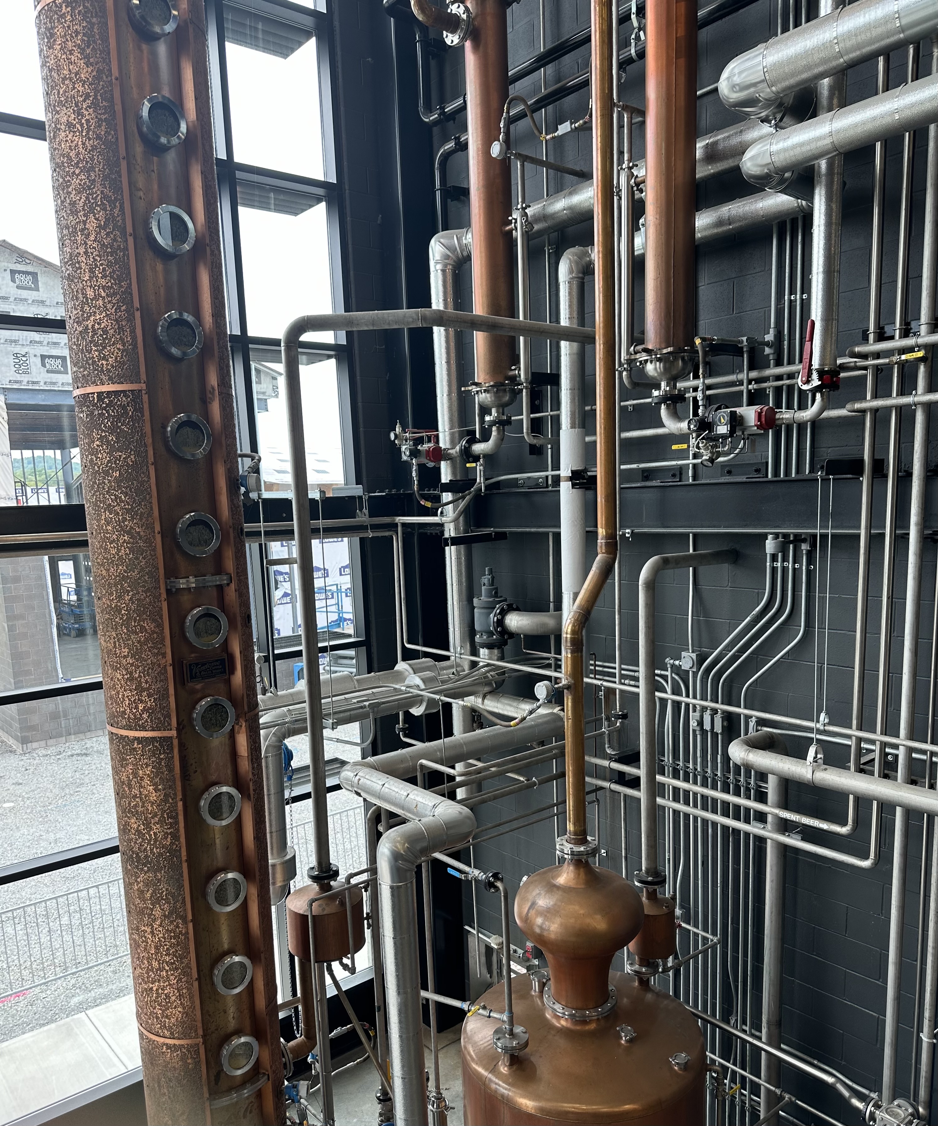 Log Still Distillery copper column still with industrial piping and plumbing