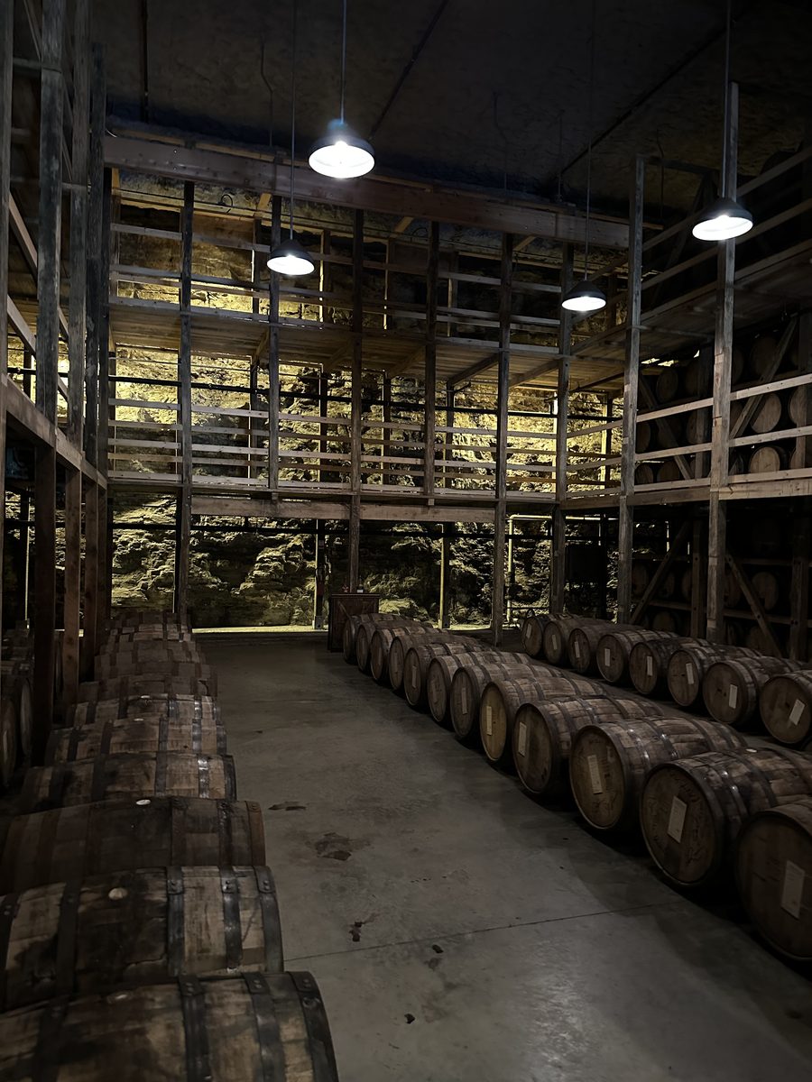 Maker's Mark limestone cellar with aging barrels and pendant lights