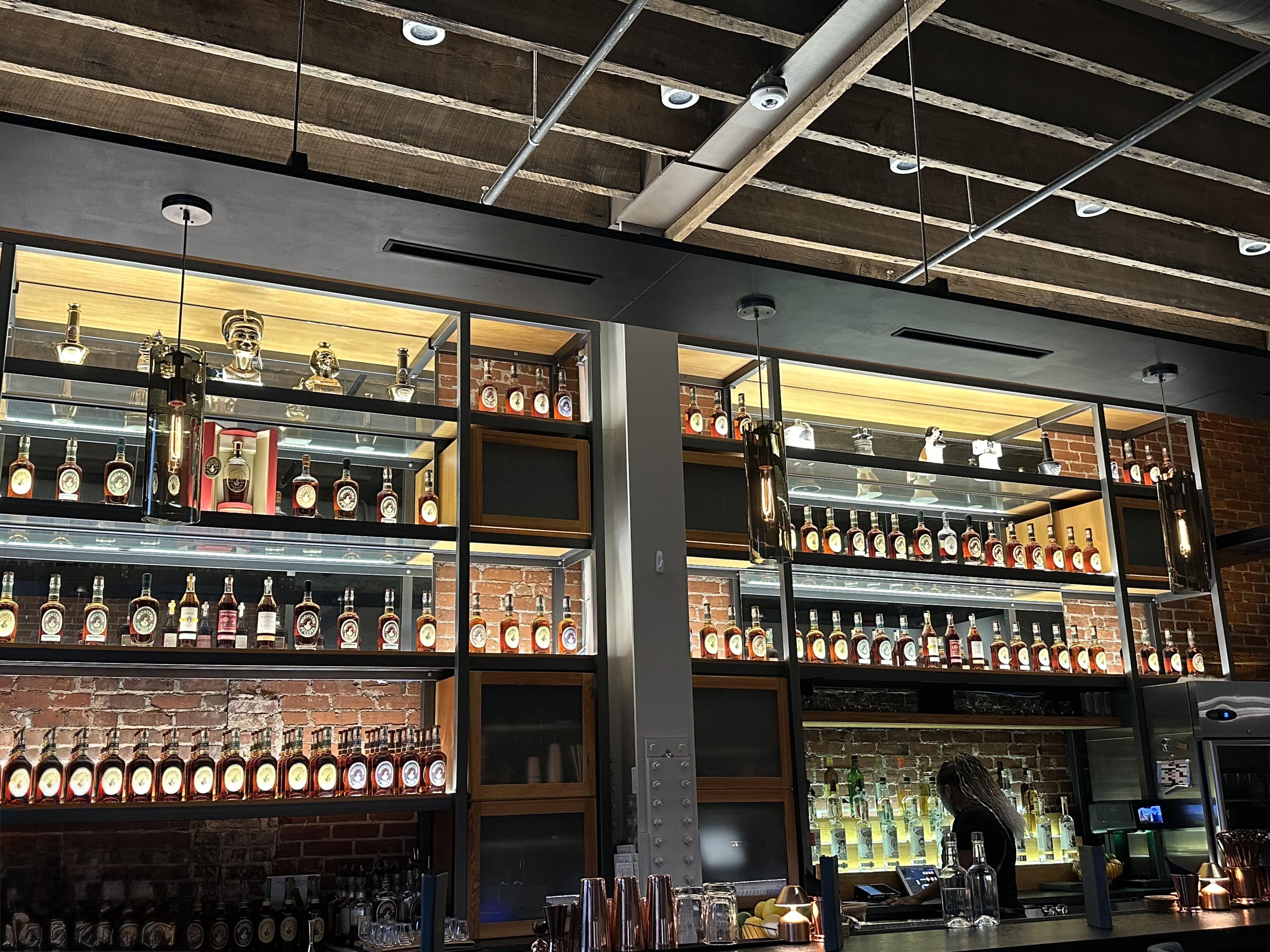 Bar 8314 at Michter's with back-lit shelves displaying rows of Michter's bottles