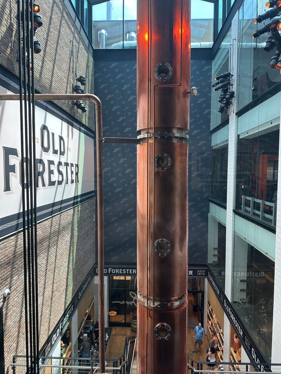 Old Forester copper column still towering through multi-story atrium