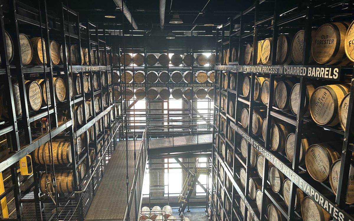 Old Forester barrel warehouse with educational signage on aging process