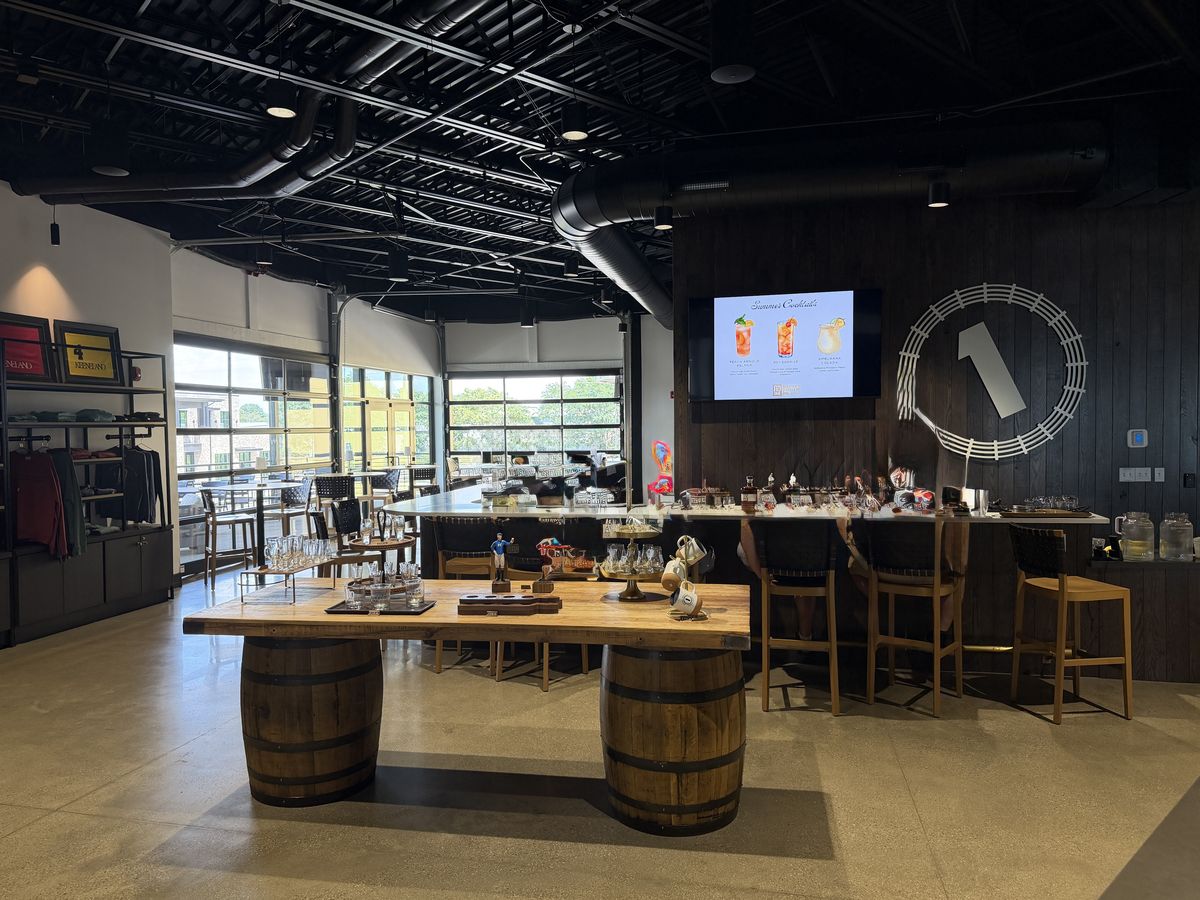 RD1 Spirits tasting room and retail floor with barrel tables and a long bar