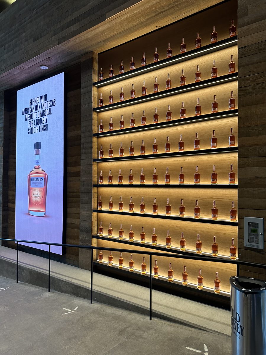 Wild Turkey Longbranch bottle wall display with backlit shelves